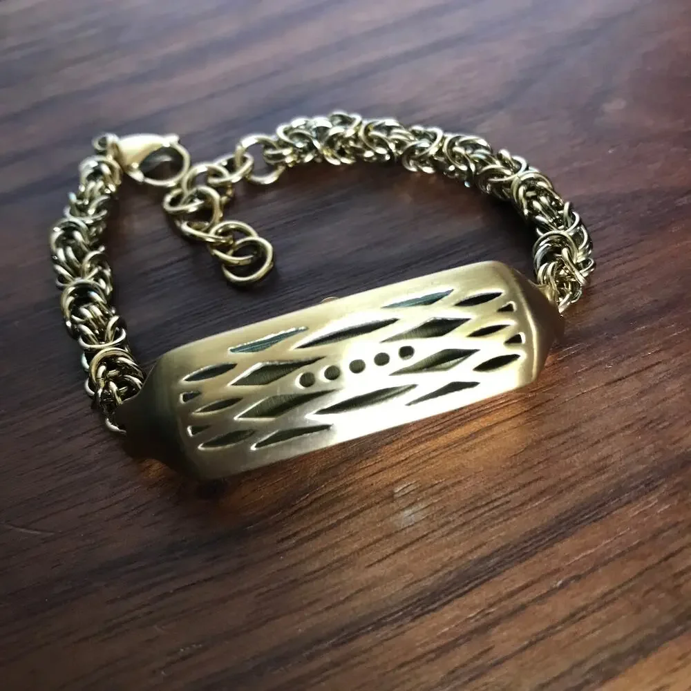 Brushed gold tone bracelet w/ a compartment for a fitbit device